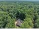 Aerial view of property surrounded by lush greenery and mature trees offering peace and privacy at 8510 Dunlee Falls Rd, Raleigh, NC 27613