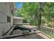Backyard featuring a small pond, partial view of the house exterior, and mature trees at 8510 Dunlee Falls Rd, Raleigh, NC 27613
