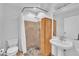 Cozy bathroom featuring a pedestal sink, walk-in shower, tile flooring, and neutral color palette at 8510 Dunlee Falls Rd, Raleigh, NC 27613