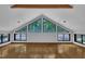 Bright loft bedroom with hardwood floors, vaulted ceilings and triangular windows at 8510 Dunlee Falls Rd, Raleigh, NC 27613