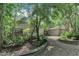 Exterior view of a modern home with gravel driveway and landscaping, surrounded by mature trees at 8510 Dunlee Falls Rd, Raleigh, NC 27613