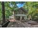 Modern home exterior showing a spacious wooden deck and contemporary design, nestled among trees at 8510 Dunlee Falls Rd, Raleigh, NC 27613