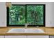 Kitchen sink and countertop with view of trees through a picture window at 8510 Dunlee Falls Rd, Raleigh, NC 27613
