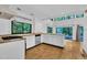 Open kitchen featuring light countertops, and an adjacent dining area with scenic outdoor views at 8510 Dunlee Falls Rd, Raleigh, NC 27613