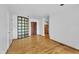Spacious living room with hardwood floors, a unique glass block window, and ample natural light at 8510 Dunlee Falls Rd, Raleigh, NC 27613