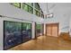 Open-concept living room boasting hardwood floors, high ceilings, and sliding doors to an outdoor deck at 8510 Dunlee Falls Rd, Raleigh, NC 27613