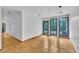 Bright living room with hardwood floors, white walls, and large windows offering scenic views at 8510 Dunlee Falls Rd, Raleigh, NC 27613