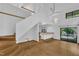 Spacious open-concept living room featuring hardwood floors, a staircase, and connecting kitchen at 8510 Dunlee Falls Rd, Raleigh, NC 27613