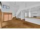Spacious open-concept living room featuring hardwood floors, a staircase, and connecting kitchen at 8510 Dunlee Falls Rd, Raleigh, NC 27613