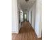 Long hallway with wood floors leading to the kitchen and bathroom at 903 New Bern Ave, Raleigh, NC 27601