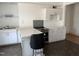 Kitchen features a breakfast bar, white cabinets, tile backsplash, and modern appliances at 903 New Bern Ave, Raleigh, NC 27601
