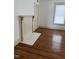 Bright living room featuring hardwood floors and an ornate faux fireplace at 903 New Bern Ave, Raleigh, NC 27601