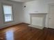 Bright living room featuring hardwood floors, fireplace, and natural light from a window at 903 New Bern Ave, Raleigh, NC 27601