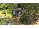 Aerial view of a lovely single-story home with a large, grassy lawn and mature trees at 918 Circle Dr, Angier, NC 27501