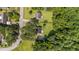An aerial view shows the home on a large lot surrounded by lush greenery and other properties at 918 Circle Dr, Angier, NC 27501