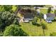 Aerial view of a house with a fenced backyard and lots of green space at 918 Circle Dr, Angier, NC 27501