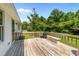Backyard deck with wood floors, wood railings, and a metal fence overlooking the lush greenery at 918 Circle Dr, Angier, NC 27501