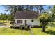 The backyard features a wooden deck, white siding, a fenced yard, and mature trees at 918 Circle Dr, Angier, NC 27501