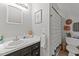 Traditional bathroom featuring wood cabinets, a white sink, wood laminate floors, and a framed mirror at 918 Circle Dr, Angier, NC 27501