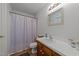 Traditional full bathroom with a white sink, a toilet, a framed mirror, a shower, and wood laminate floors at 918 Circle Dr, Angier, NC 27501