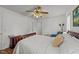 Bedroom featuring neutral walls, wood laminate floors, a ceiling fan, a bed, and two closets at 918 Circle Dr, Angier, NC 27501