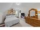 Cozy bedroom with slanted ceilings, neutral walls, carpet, a ceiling fan, and a window at 918 Circle Dr, Angier, NC 27501