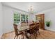 Well-lit dining room with a wooden table, six chairs, and a large window for natural light at 918 Circle Dr, Angier, NC 27501