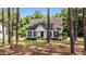 Beautiful single-story home with a manicured lawn and mature trees surrounding the property at 918 Circle Dr, Angier, NC 27501