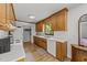 Bright kitchen with wooden cabinets, white countertop, and a view of the backyard from the window at 918 Circle Dr, Angier, NC 27501