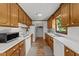 Traditional style kitchen features wood cabinets, white appliances, and a window overlooking the yard at 918 Circle Dr, Angier, NC 27501