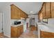 Functional kitchen with white appliances, wood cabinets, laminate flooring, and ample counter space at 918 Circle Dr, Angier, NC 27501