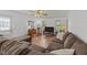 Comfortable living room with a large sectional sofa, laminate floors, and natural light from the windows at 918 Circle Dr, Angier, NC 27501