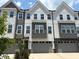 View of new construction townhome with a gray garage door and white and gray accents on the exterior at 1007 Regalia Rd # 31, Durham, NC 27713