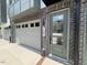 Close up of townhouse front door featuring an attached garage and brick accents at 1007 Regalia Rd # 31, Durham, NC 27713
