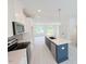 Modern kitchen with stainless steel appliances, white cabinetry, and an island with quartz countertops at 1007 Regalia Rd # 31, Durham, NC 27713