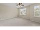 Comfortable bedroom with neutral carpeting, ceiling fan, and natural light at 109 Grey Elm Trl, Durham, NC 27713