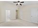 Spacious bedroom with multiple doorways, neutral walls, carpet and ceiling fan at 109 Grey Elm Trl, Durham, NC 27713