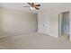 Spacious bedroom with carpet, ceiling fan, and access to the bathroom at 109 Grey Elm Trl, Durham, NC 27713