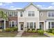 Charming multi-story townhome featuring a well-manicured front yard and a welcoming entrance at 109 Grey Elm Trl, Durham, NC 27713