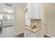 Charming kitchen featuring an arched doorway, white cabinets, and decor at 109 Grey Elm Trl, Durham, NC 27713