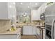 Well-lit kitchen with white cabinets and stainless steel appliances at 109 Grey Elm Trl, Durham, NC 27713
