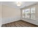 Bright living room with paneled walls, wood floors, fresh paint and natural light at 109 Grey Elm Trl, Durham, NC 27713