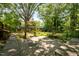 Enjoy a lovely yard with mature plants and a small wooden shed for storage at 111 Lattimore Ln, Durham, NC 27713