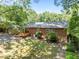 Backyard featuring a wooden deck, brick exterior, and serene landscaping at 111 Lattimore Ln, Durham, NC 27713
