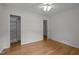 Bright bedroom with wood floors features a ceiling fan and closet at 111 Lattimore Ln, Durham, NC 27713