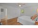 Well-lit bedroom boasts a ceiling fan, double closets, and a picturesque window view at 111 Lattimore Ln, Durham, NC 27713