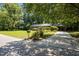 A well-maintained driveway leads to a charming home with lush landscaping at 111 Lattimore Ln, Durham, NC 27713