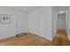 Hallway with wood floors, white walls, closet, and entry door at 111 Lattimore Ln, Durham, NC 27713