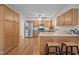Open kitchen with stainless steel appliances, wood cabinets, and a breakfast bar with seating at 111 Lattimore Ln, Durham, NC 27713