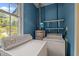 Functional laundry room with washer, dryer, and water heater set against blue walls at 111 Lattimore Ln, Durham, NC 27713